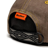 Buy Butter Goods Rounded Logo 6 Panel Cap Washed Oakwood. Distressed washed cotton 6 panel construct. Contrast stitching. Embroidered details on front. Self fabric strap closure at back. Fast free UK Delivery & Buy now pay later at Tuesdays. #1 UK destination for Butter Goods in the U.K.